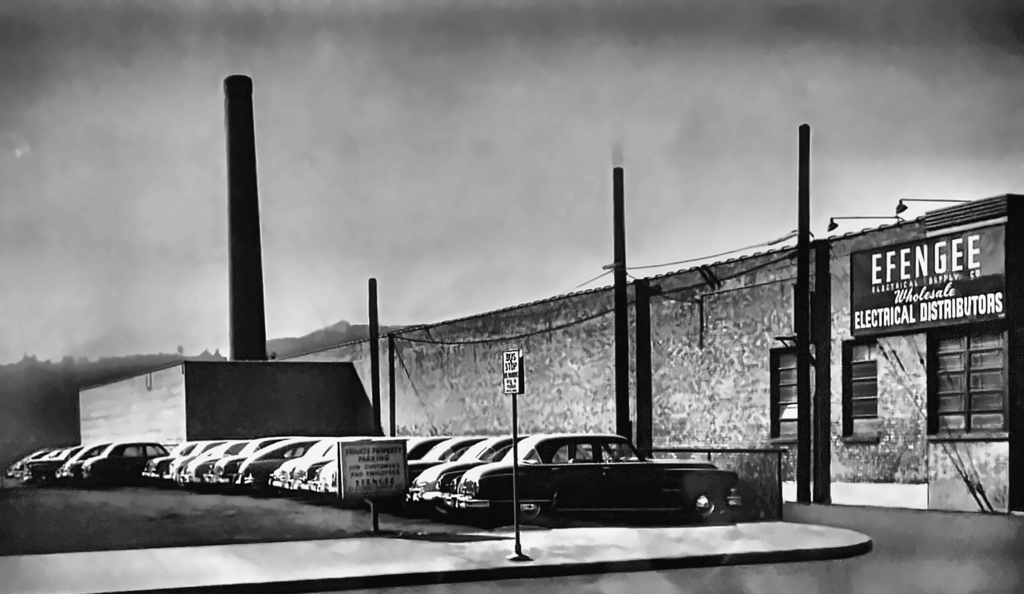 Historic photo of the Efengee Electrical Supply Co. storefront, wholesale electrical distributors, with cars parked out front
